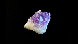 An amethyst cluster photographed on an ultra-black background