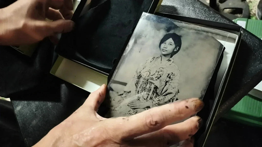 A wet-plate portrait in kimono, held over its gift box lined with black fabric